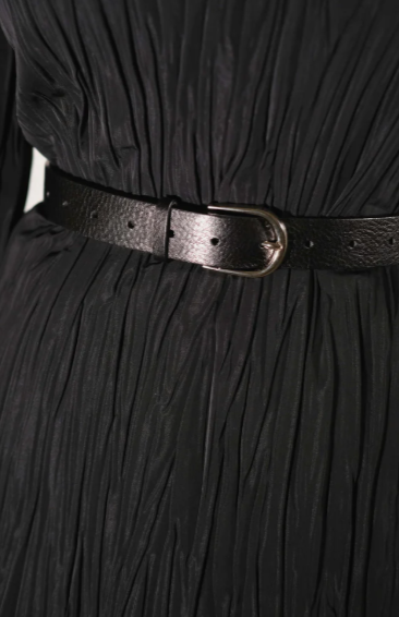 Black pleated dress with a belt on a plain background
