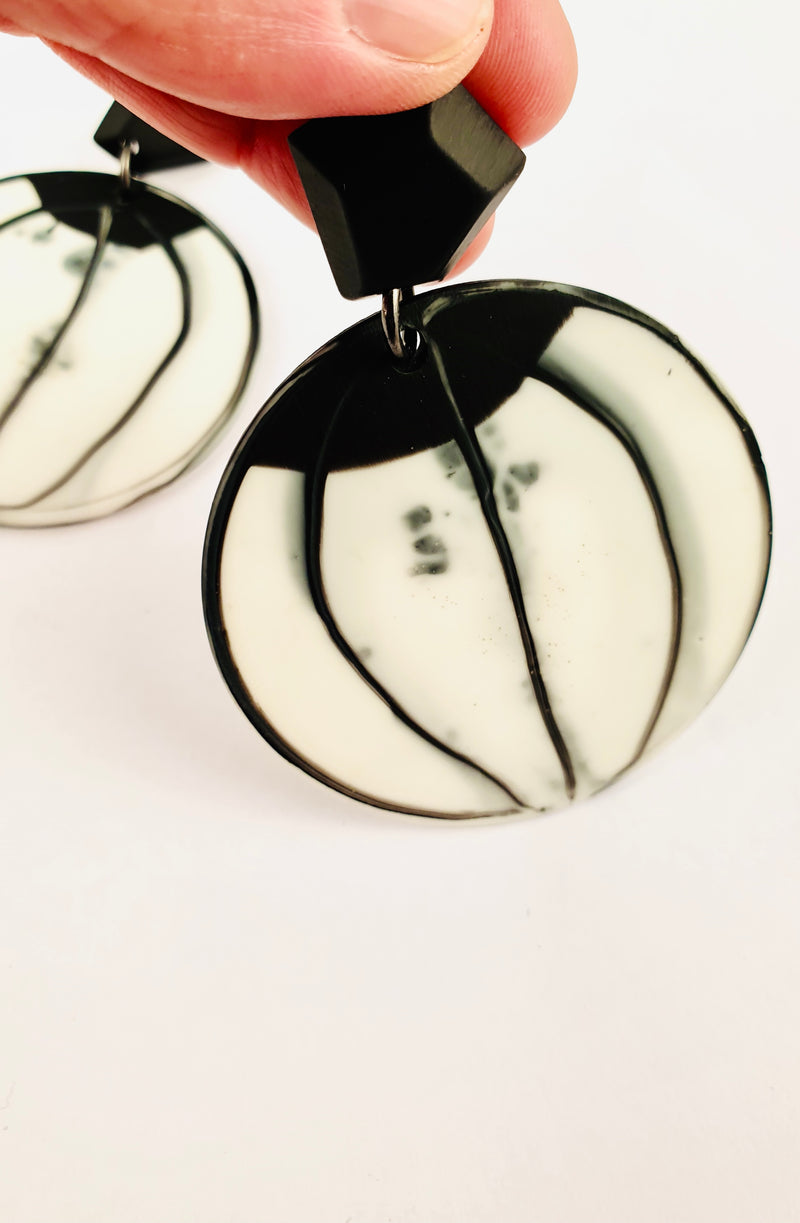 Black and white round earrings